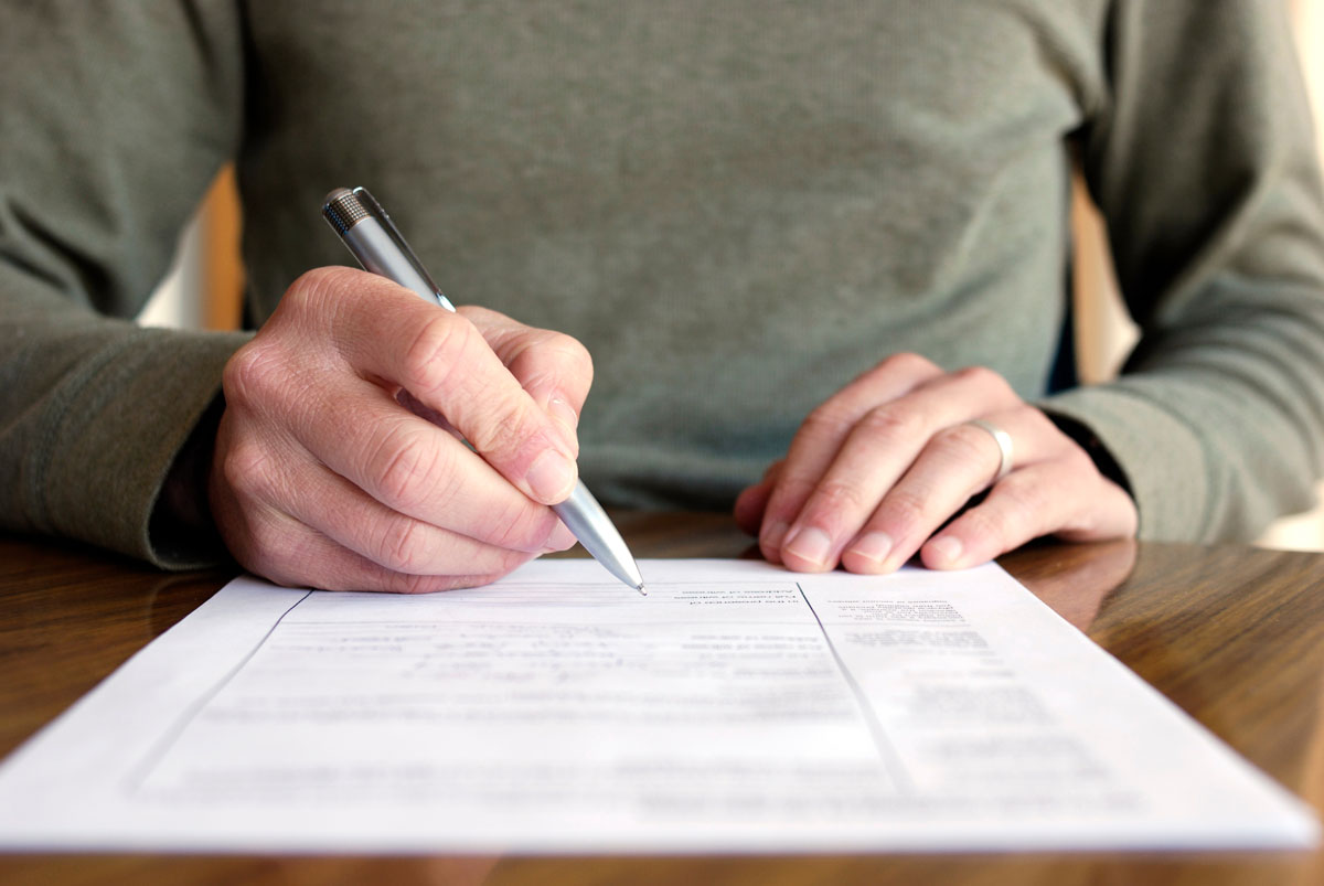 A person filling out a paper form.