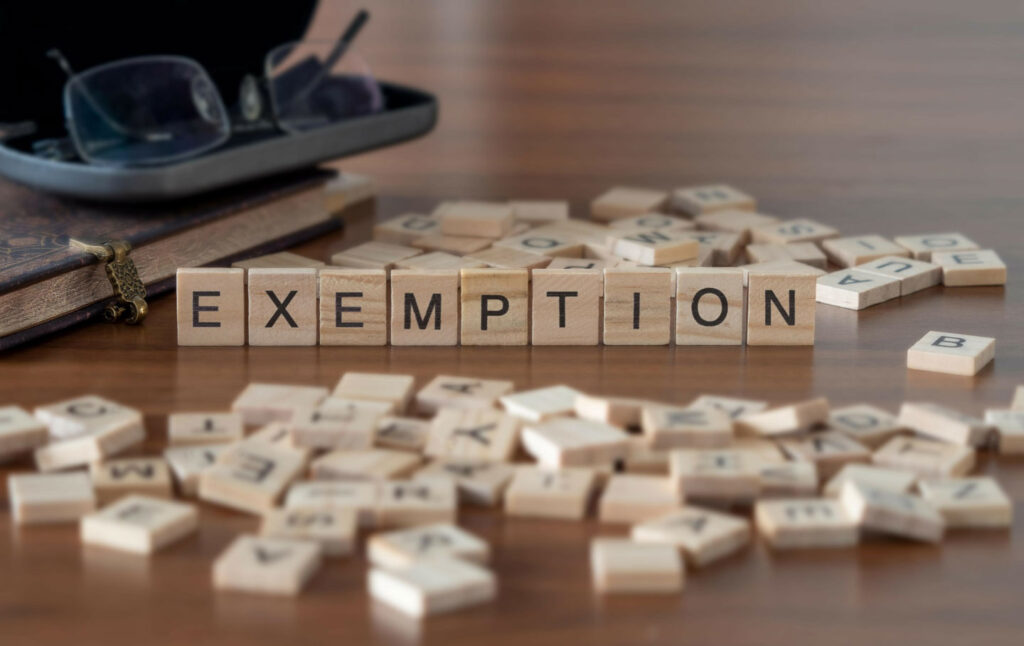 The word exemption spelled out on scrabble letters.