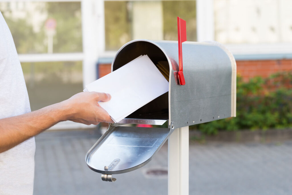 A person checking the mailbox for letters.