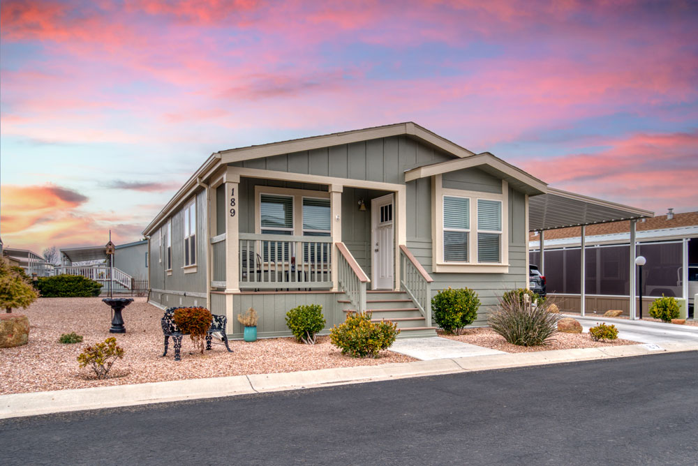 A nice manufactured home with a sunset background.